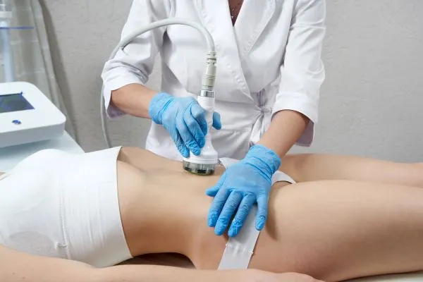 Lost the Weight but Not the Loose Skin? 2 woman having HIFU treatment on her stomach to combat loose skin Woking following weight loss